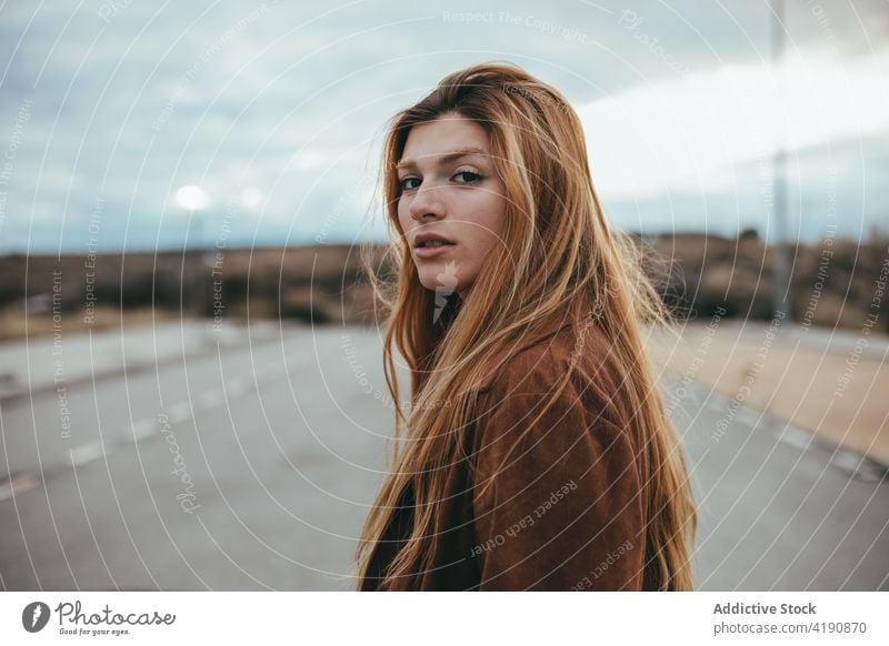 Stylish calm lady looking at camera on street woman confident style rest appearance personality tranquil street style city fashion female young long hair