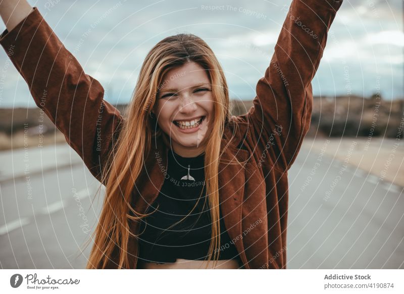 Happy lady looking at camera on street woman confident style appearance personality tranquil street style city fashion young long hair ginger hair trendy cool