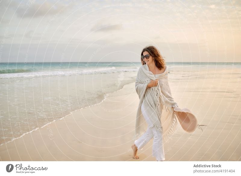 Woman on beach in summer wet seashore woman walk water cliff seaside female relax travel tourism traveler coast ocean rock nature happy vacation holiday stone