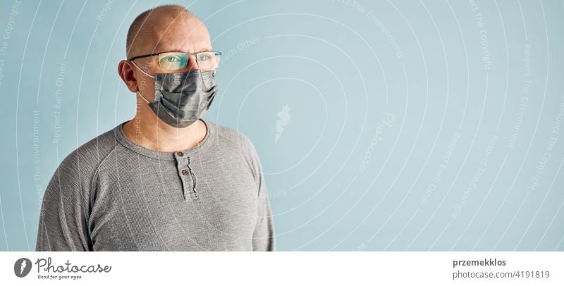 Man patient with face mask. Wearing coronavirus covid-19 protection medical mask during the pandemic person male disease health care hygiene copy space man