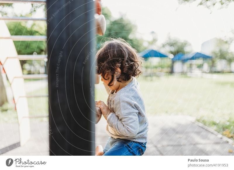 Cute girl playing at playground Climbing wall Child childhood 1 - 3 years Caucasian Girl Playing Playground Happy Happiness Leisure and hobbies Colour photo Joy