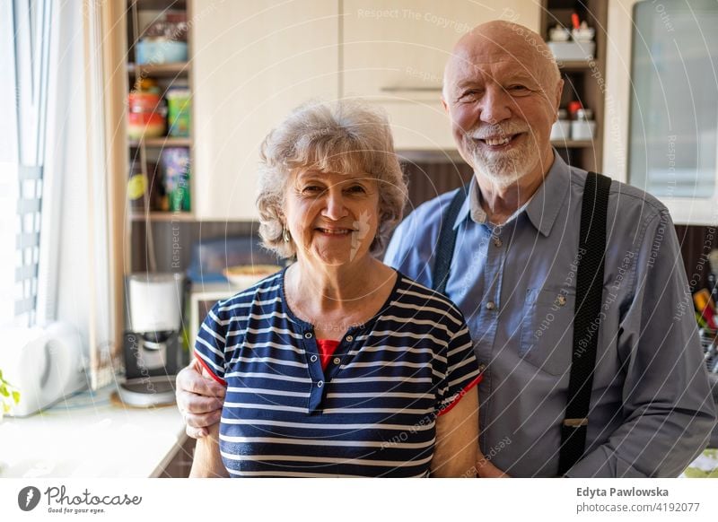 Happy senior couple together at home real people candid genuine woman mature female love bonding Caucasian elderly house old aging domestic life grandmother