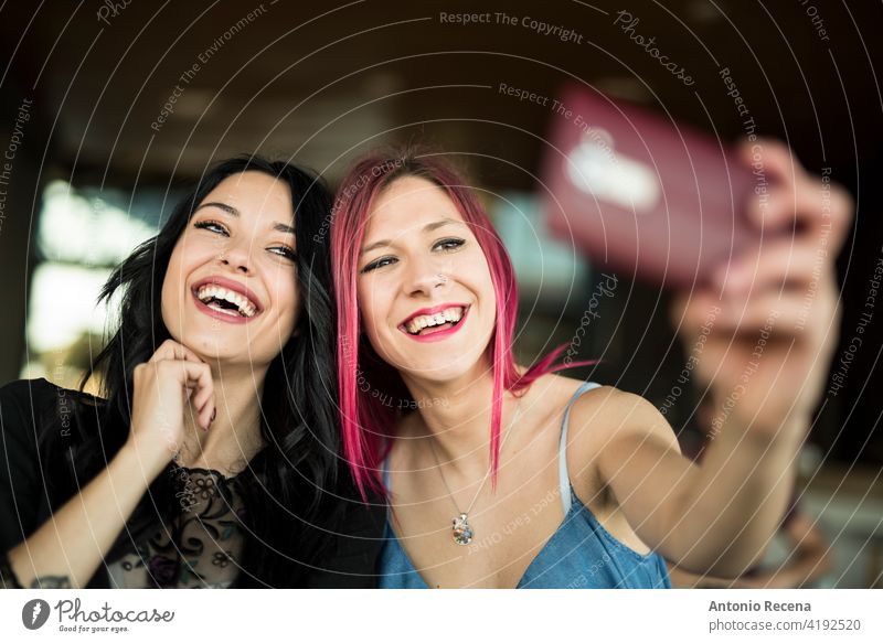 happy woman taking self portrait in bar smiling and posing young attractive 20s joy people person youth urban women pretty pretty people selfie Self portrait