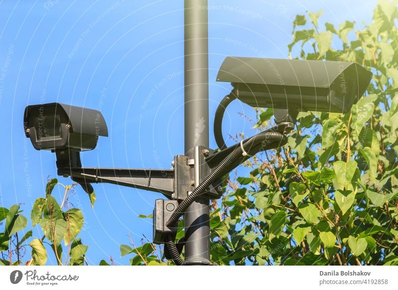 outdoor video surveillance cameras installed in several d cctv security safety property system background green technology equipment protection control lens