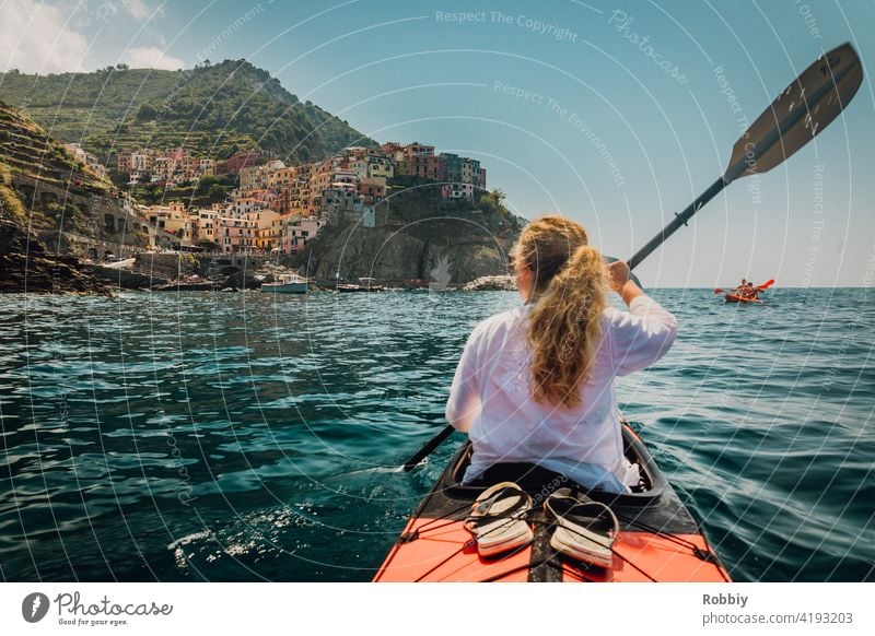 By kayak towards Manarola from Cinque Terre Italy La Spezia vacation coast holidays Southern Europe Tourism Mediterranean sea coastal town tourist magnet