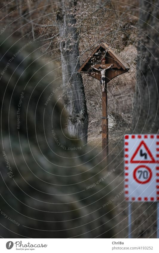 Warning sign and wayside cross on a motorcycle route in the Swabian Alb symbol road warning danger traffic deposit drive accident roadsign guard vehicle careful