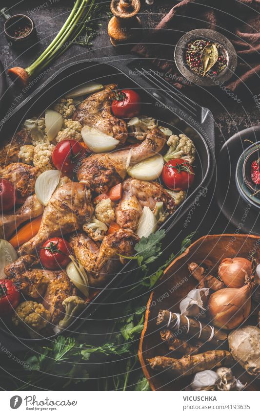 Tasty chicken drumsticks in cast iron pan with vegetables. Close up tasty close up cooking homemade bbq background leg grilled tomato poultry food meal meat