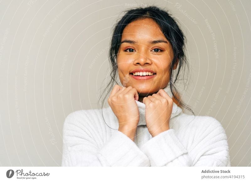 Long-haired brunette Asian woman dressed in a white sweater looking at camera japanese asian young female model chinese style attractive lady street modern