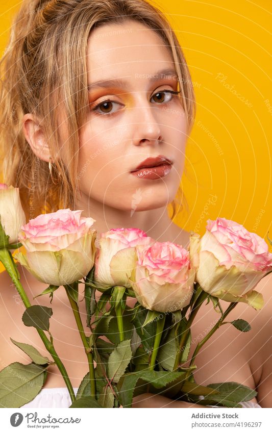 Stylish woman with pink roses standing in studio flower style trendy outfit blossom fragrant flawless gorgeous sensitive beautiful young attractive pretty flora