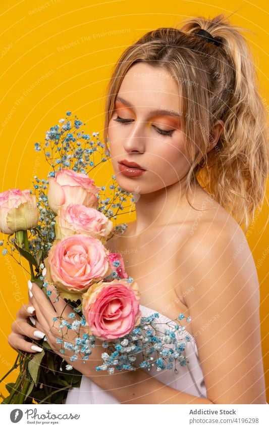 Stylish woman with pink roses standing in studio flower style trendy outfit blossom fragrant flawless gorgeous sensitive beautiful young attractive pretty flora