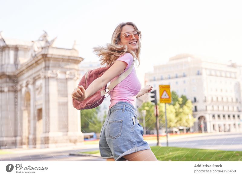 Joyful young woman enjoying vacation on city street happy teenage holiday travel fun carefree pleasure female cheerful sunshine optimist lifestyle smile trip