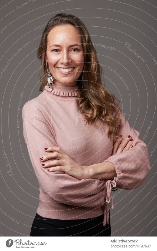 Happy businesswoman in studio portrait mature female cheerful happy confident looking at camera adult caucasian smiling lady attractive studio shot elegant