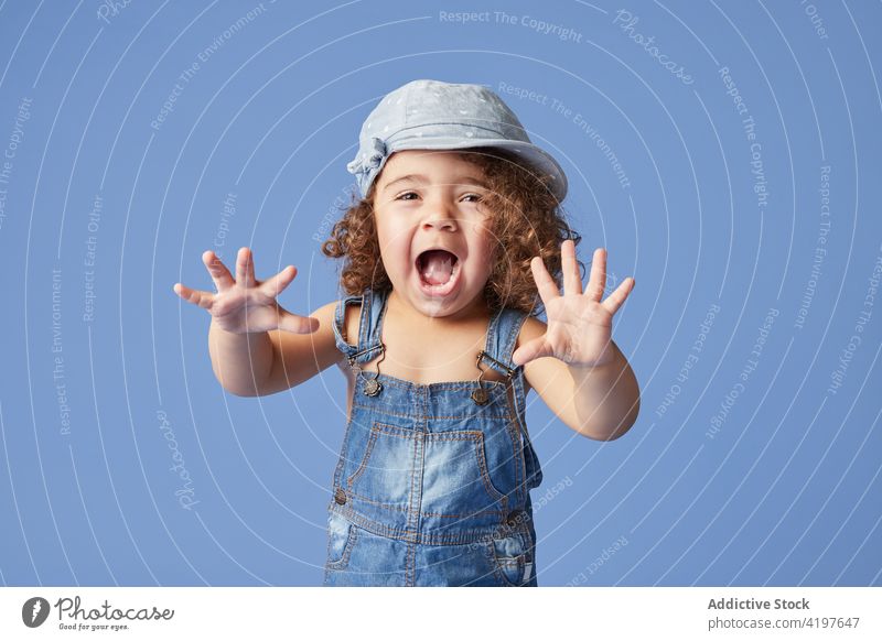 Cute toddler girl in casual wear on blue background dance carefree charming childhood barefoot sweet denim dress natural adorable summer friendly tender