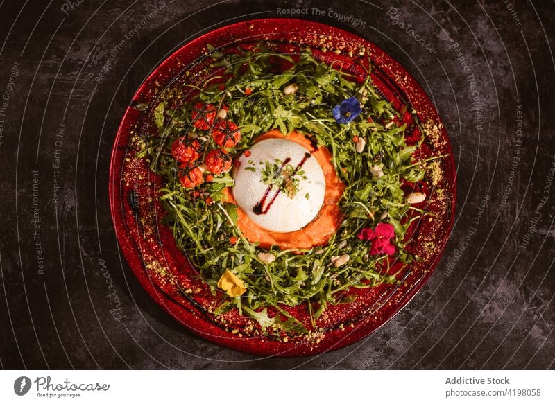 Tasty burrata with fresh herbs on plate gastronomy gourmet vegan lunch dinner meal condiment cheese arugula truffle aroma cherry tomato flower soft seasoning