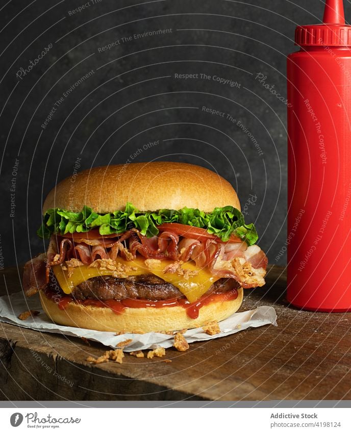 Delicious cheeseburger on wooden table hamburger beef onion sandwich junk ingredient dinner melted one crispy onion lettuce unhealthy cooked takeaway eat