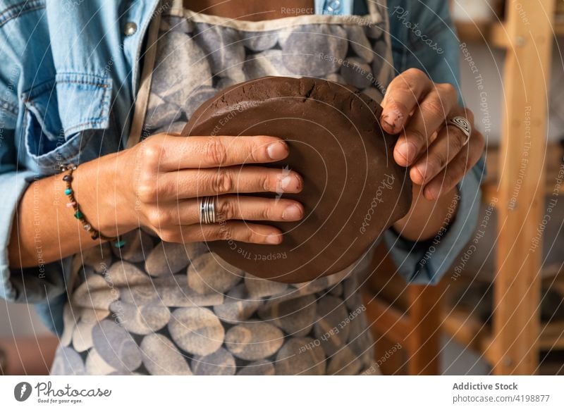 Faceless man making clay product in workshop pottery artisan clayware handmade craft mold skill small business male talent create master plate occupation shape