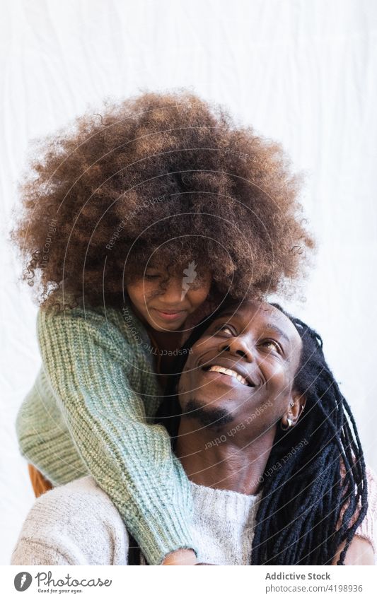 Loving daughter gently embracing cheerful father embrace gentle bonding close glad love caress girl dad man dreadlocks child afro enjoy parenthood fatherhood