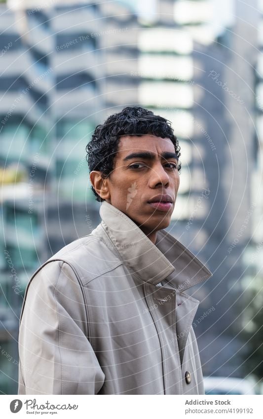 Stylish ethnic man reflecting in building on the street fashion trendy individuality style contemporary reflection town glass building garment stylish apparel