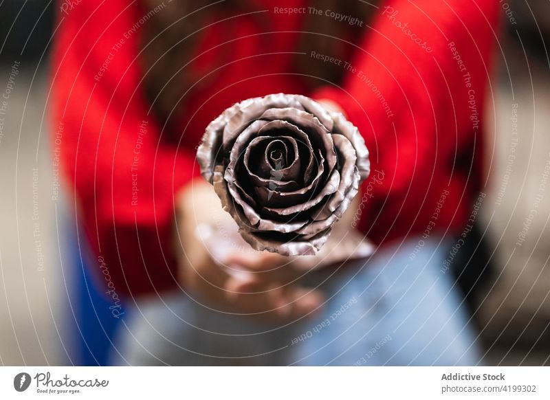 Woman showing rose bud made of metal woman flower forge metalwork sharp handwork craft workshop female blacksmith creative steel iron create craftsman industry