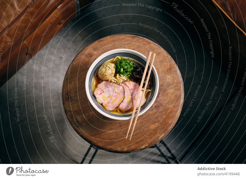 Ramen in bowl with chopsticks on table ramen soup dish tradition oriental meal japanese cuisine delicious tasty serve gastronomy food nutrition gourmet recipe