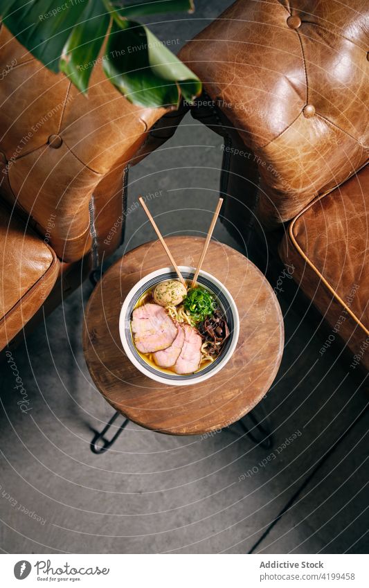 Ramen in bowl with chopsticks on table ramen soup dish tradition oriental meal japanese cuisine delicious tasty serve gastronomy food nutrition gourmet recipe