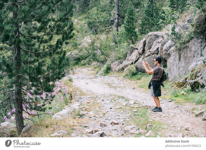 Crop backpacker taking photo of landscape on smartphone trekker take photo screen vacation explore moment memory man using gadget device trip cellphone