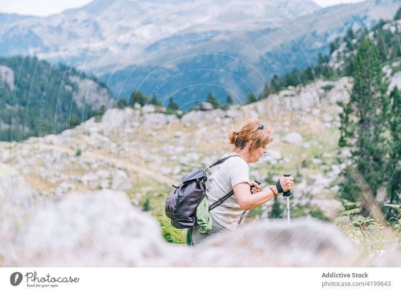 Active woman walking with poles on stony hill slope pole walking active path energy trekking nordic walking physical concentrate tourism focus ruda valley adult