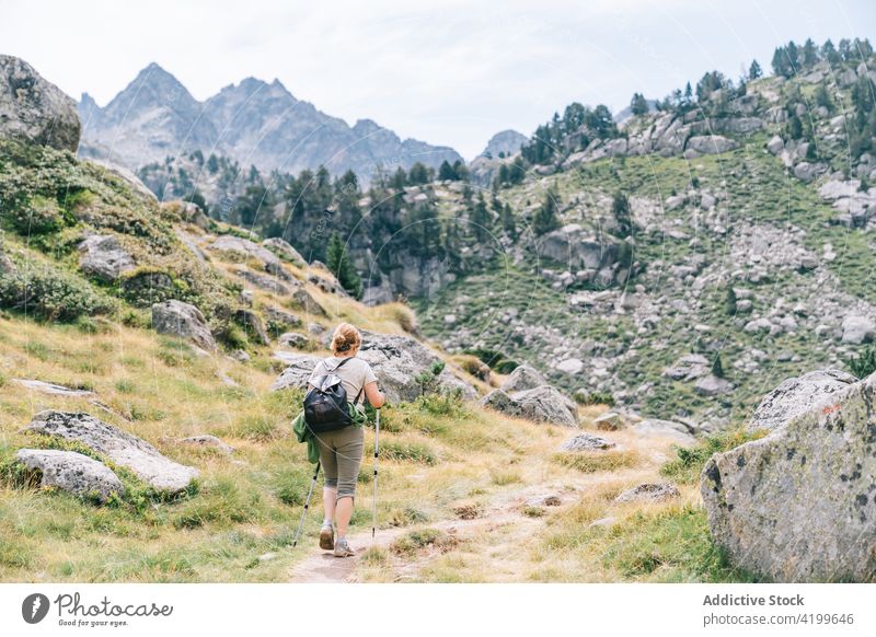 Anonymous active woman walking with poles on stony hill slope pole walking path energy trekking nordic walking physical tourism focus ruda valley adult lleida