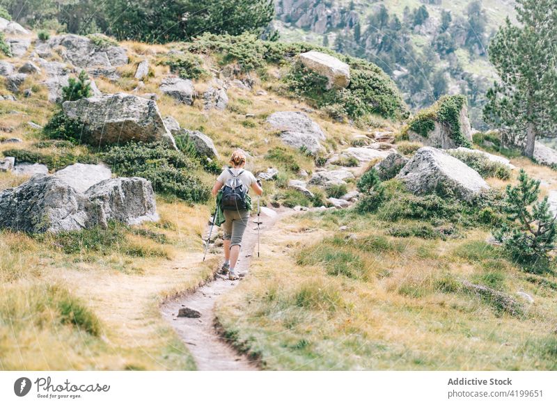 Anonymous active woman walking with poles on stony hill slope pole walking path energy trekking nordic walking physical tourism focus ruda valley adult lleida