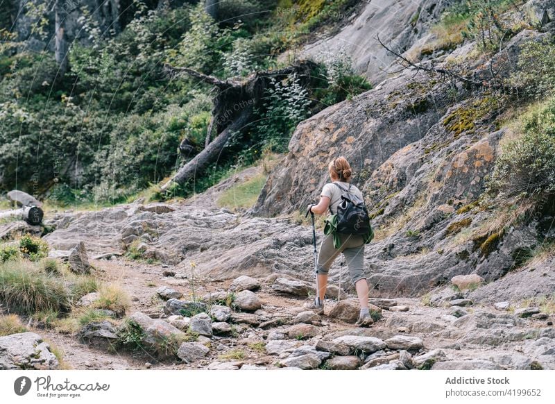 Anonymous active woman walking with poles on stony hill slope pole walking path energy trekking nordic walking physical tourism focus ruda valley adult lleida