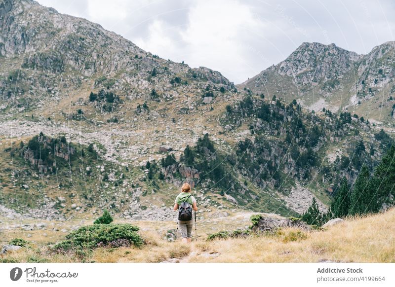 Anonymous active woman walking with poles on stony hill slope pole walking path energy trekking nordic walking physical tourism focus ruda valley adult lleida