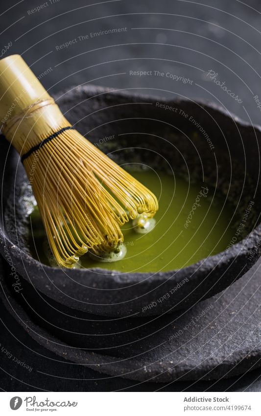 Bowl with aromatic matcha tea with chasen whisk bowl oriental teatime culture brew ceremony natural national beverage authentic stone healthy bamboo herbal