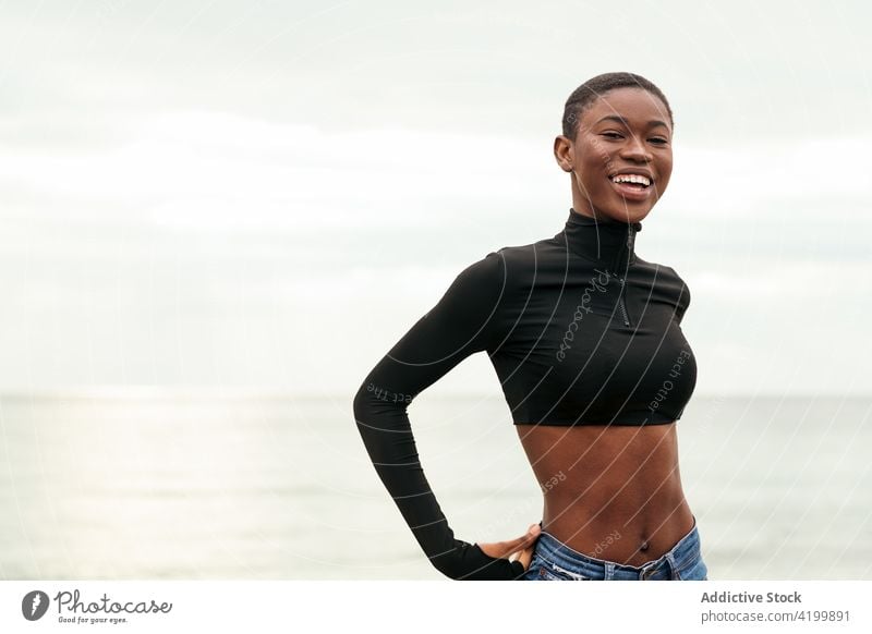 Trendy black model on sea shore woman short hair seashore style sensitive belly gentle portrait trendy tender romantic feminine sincere african american coast