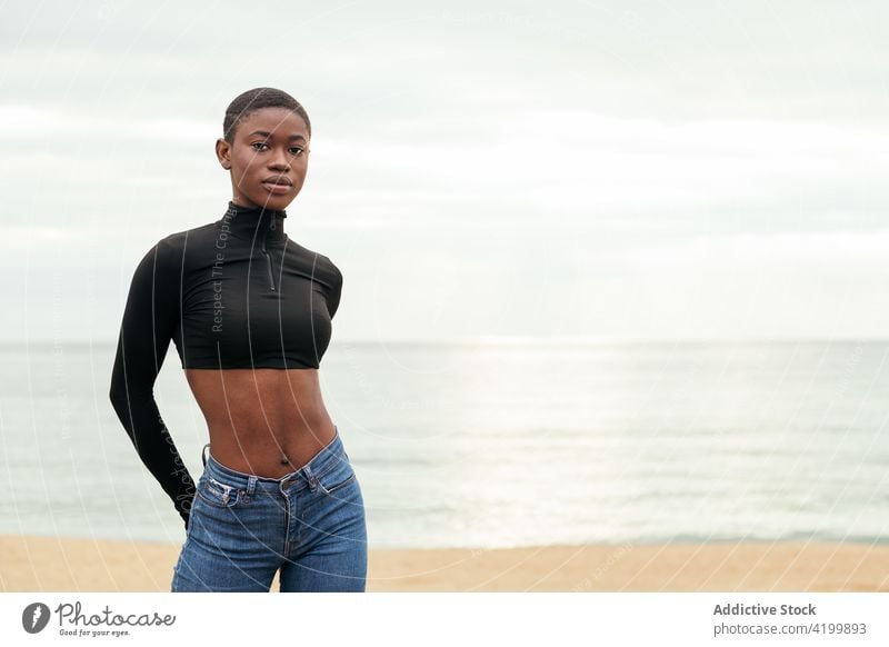 Trendy black model on sea shore woman short hair seashore style sensitive belly gentle portrait trendy tender romantic feminine sincere african american coast