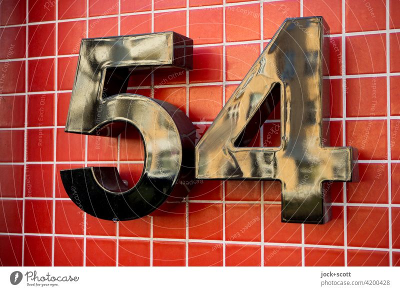 black number 54 on red tiles Signs and labeling Characters Digits and numbers Structures and shapes Orientation marks Design Tile Typography Reflection