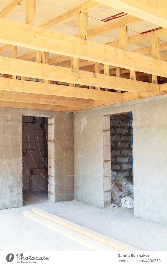 view of wooden rafters when installing roof on construction of house ceiling frame beam interior timber building beams plank estate inside architecture