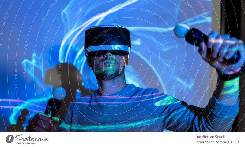 Man in VR goggles exploring virtual reality man vr headset touch experience explore illuminate projector technology innovation gadget entertain digital glasses