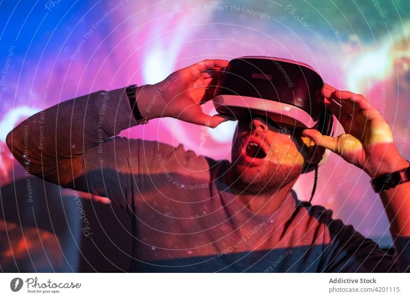 Man in VR goggles exploring virtual reality man vr headset touch experience explore illuminate projector technology innovation gadget entertain digital glasses