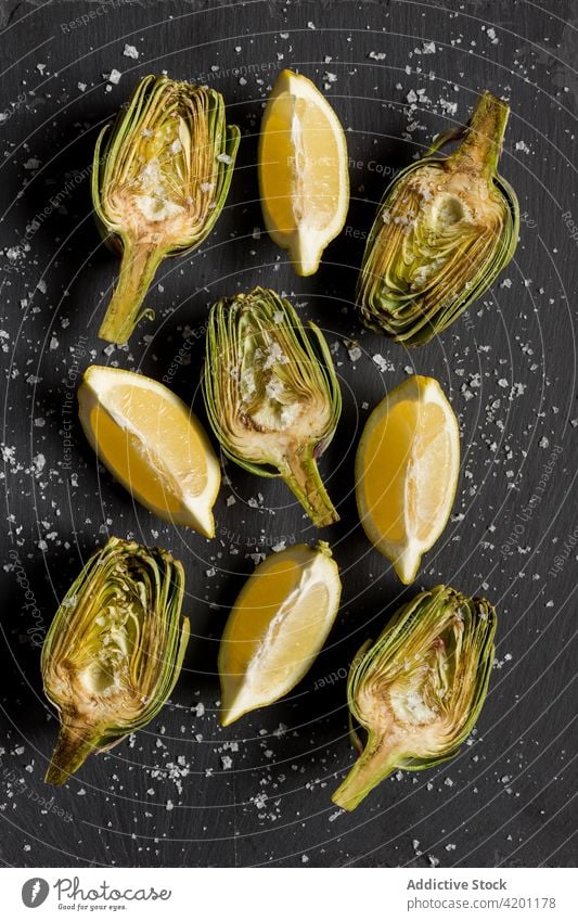 Fresh artichokes arranged in rows on table green plant half nutrition ripe food healthy edible organic vitamin harvest vegan order even fresh natural raw