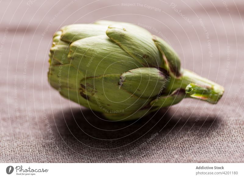 Green artichoke on shabby metal table green plant rust edible food healthy vitamin surface organic nutrition harvest vegan fresh ripe natural raw ingredient