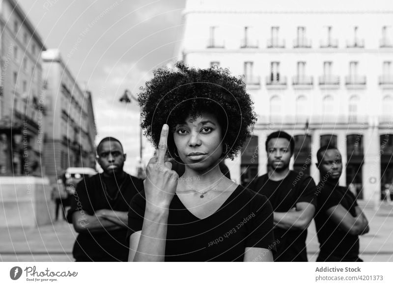 Confident black protesters showing middle finger on city street sjw fuck blm racism rude rebel justice arms crossed portrait woman men black lives matter