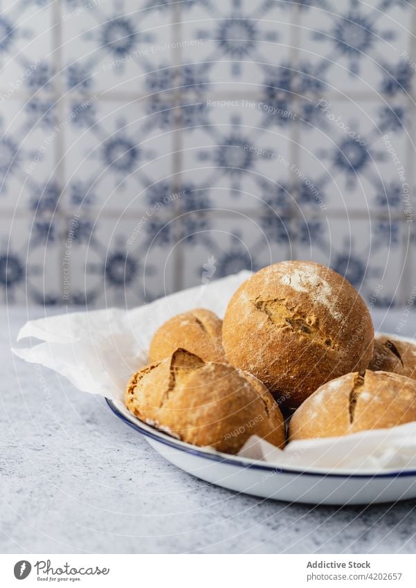 Fresh bread buns on plate in kitchen baked fresh appetizing tasty pastry nutrition delicious culinary cuisine gastronomy tradition yummy cook recipe bakery