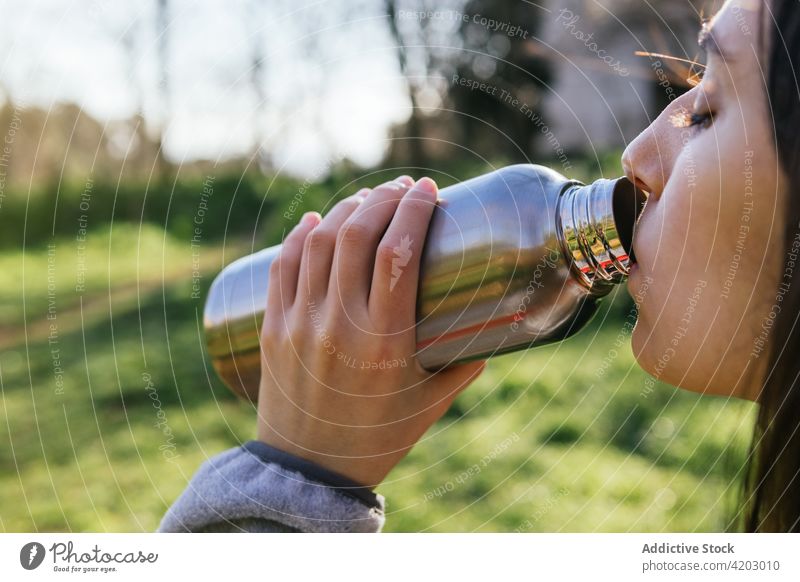 Female traveler drinking water in nature hiker woman summer thirst bottle female fresh forest metal aqua refreshment clear beverage holiday woods lady vacation