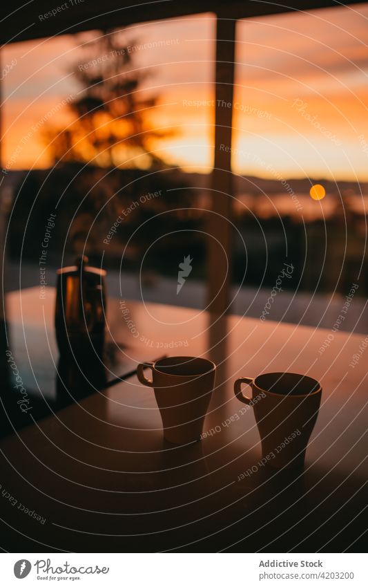 Cups and geyser coffee maker on table against sunset sky cup dusk hot drink beverage coffeemaker aroma mug house fresh caffeine brew spectacular sundown warm