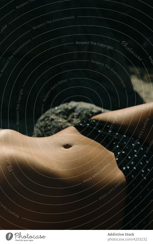 Close-up of the belly of a woman who is lying sunbathing in a bikini body waist skin slim female close up white health beauty fitness figure swimwear hips