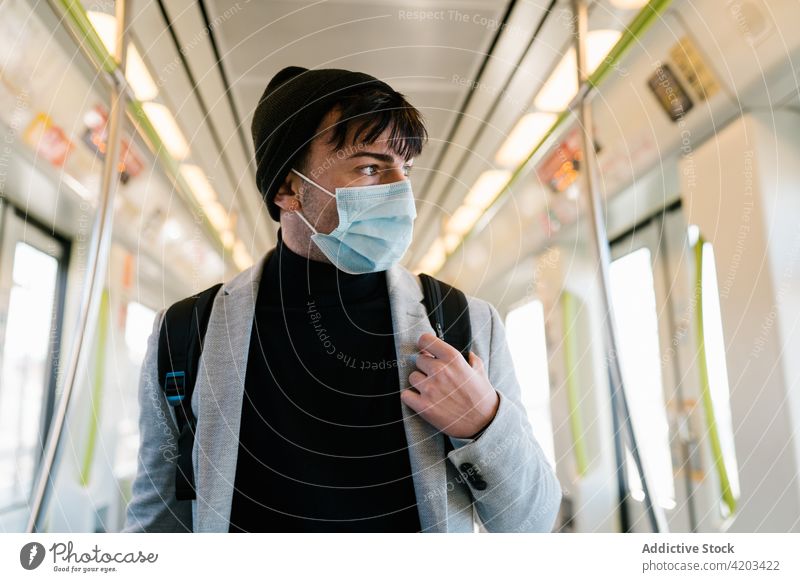 Man on face mask in modern train man commute wagon student carriage backpack transport empty public male contemporary ride passenger urban style railway