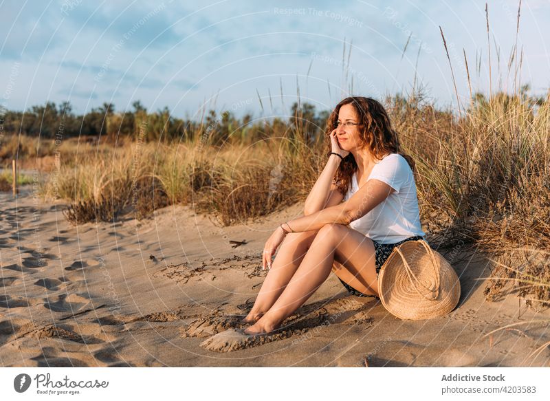 Carefree woman enjoying sunset on beach tranquil freedom serene carefree summer shore female sundown relax calm lean on hand sand harmony seaside dusk seashore