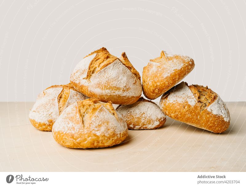 Appetizing bread with crunchy crust on table fresh natural product baked scent flour bakery delicious aroma appetizing shape round pile similar tasty wheat