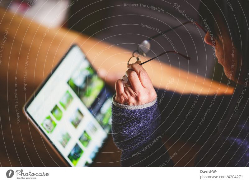 Woman uses a tablet Computer search read up technology Modern Internet Digital Online Eyeglasses