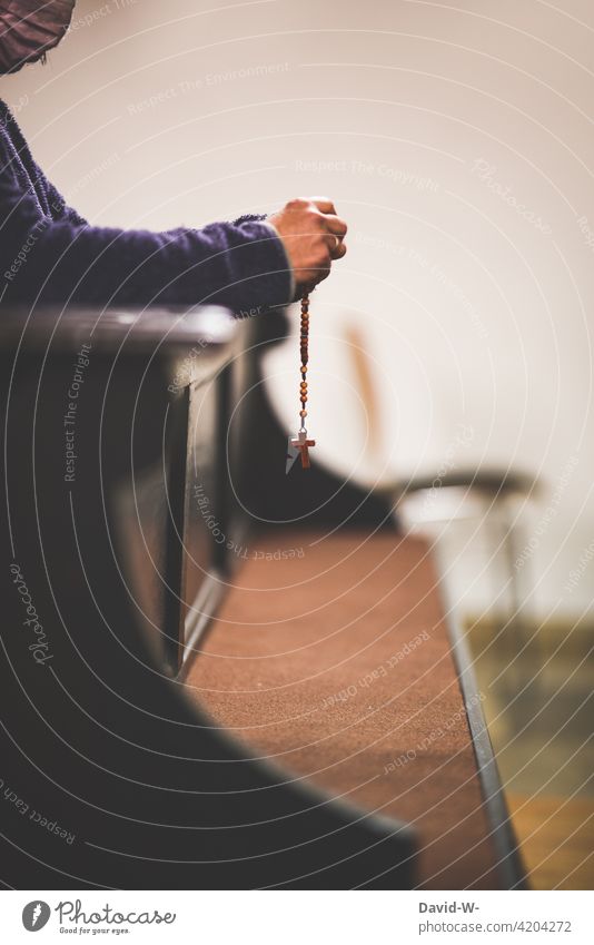 Woman with breathing mask and rosary praying in a pew Church pandemic coronavirus Rosary Hope Belief Prayer God Grief Fears Fear of the future